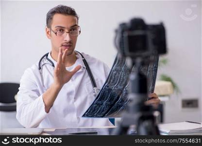 The young male doctor radiologist recording video for his blog. Young male doctor radiologist recording video for his blog
