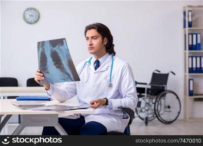The young male doctor radiologist working in the clinic . Young male doctor radiologist working in the clinic 
