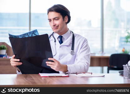 The young male doctor radiologist working in the clinic . Young male doctor radiologist working in the clinic