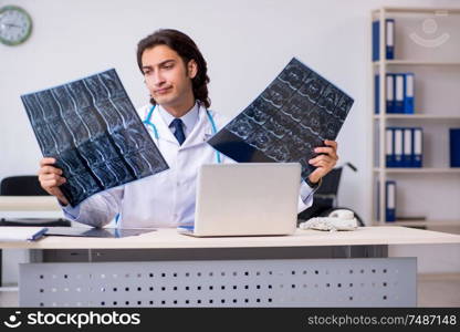 The young male doctor radiologist working in the clinic. Young male doctor radiologist working in the clinic