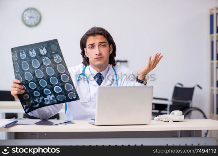 The young male doctor radiologist working in the clinic. Young male doctor radiologist working in the clinic