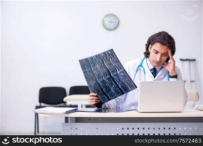 The young male doctor radiologist working in the clinic. Young male doctor radiologist working in the clinic