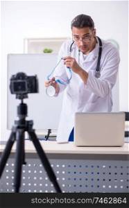 The young male doctor recording video for his blog . Young male doctor recording video for his blog 