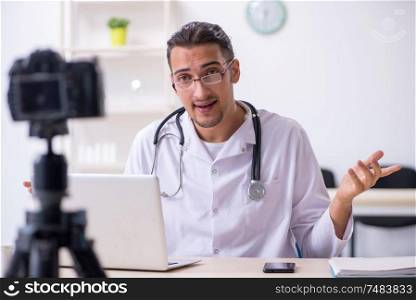 The young male doctor recording video for his blog. Young male doctor recording video for his blog