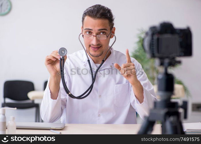 The young male doctor recording video for his blog. Young male doctor recording video for his blog