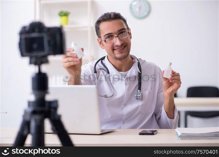 The young male doctor recording video for his blog. Young male doctor recording video for his blog