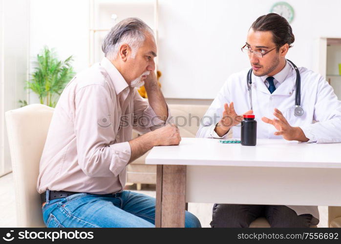 The young male doctor visiting old patient at home. Young male doctor visiting old patient at home