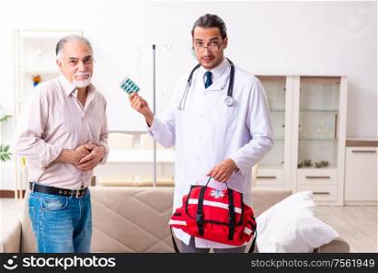 The young male doctor visiting old patient at home. Young male doctor visiting old patient at home