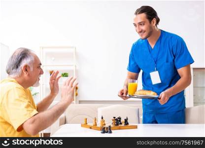 The young male doctor visiting old patient at home. Young male doctor visiting old patient at home