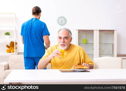 The young male doctor visiting old patient at home. Young male doctor visiting old patient at home