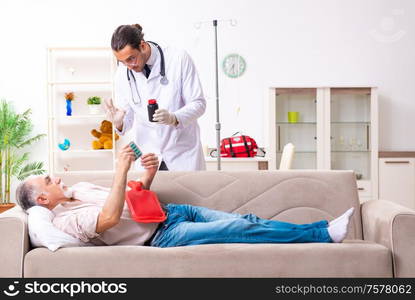 The young male doctor visiting old patient at home. Young male doctor visiting old patient at home