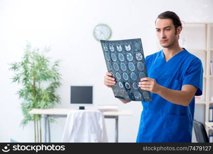 The young male doctor working in the clinic . Young male doctor working in the clinic