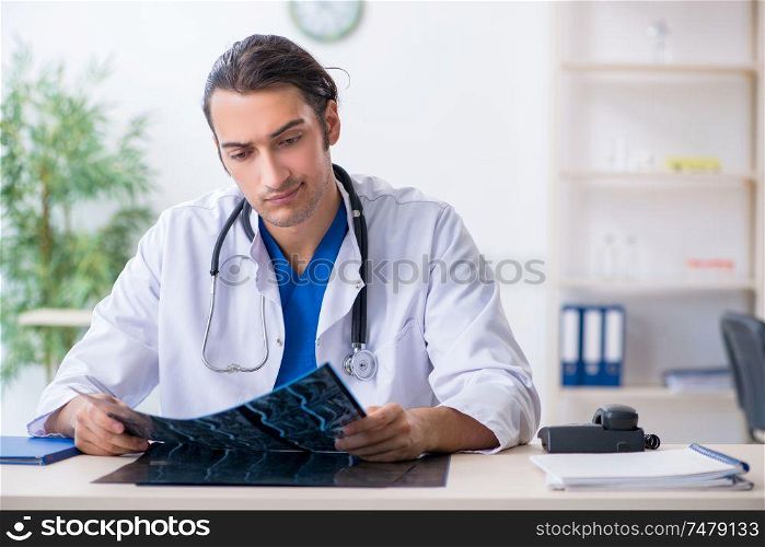 The young male doctor working in the clinic . Young male doctor working in the clinic