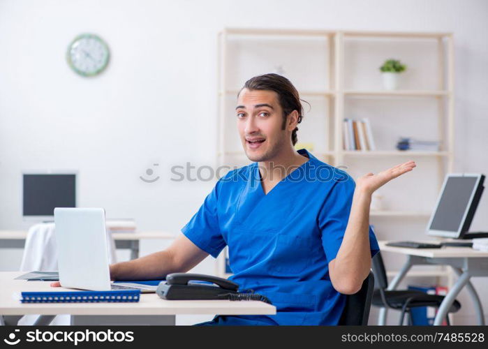 The young male doctor working in the clinic. Young male doctor working in the clinic