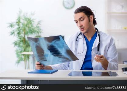 The young male doctor working in the clinic . Young male doctor working in the clinic
