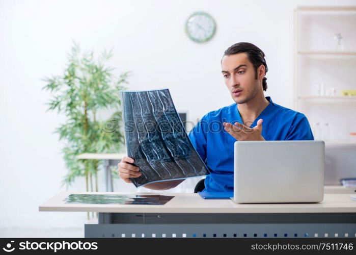 The young male doctor working in the clinic. Young male doctor working in the clinic