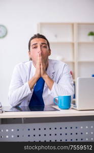 The young male doctor working in the clinic. Young male doctor working in the clinic