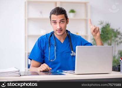 The young male doctor working in the clinic. Young male doctor working in the clinic