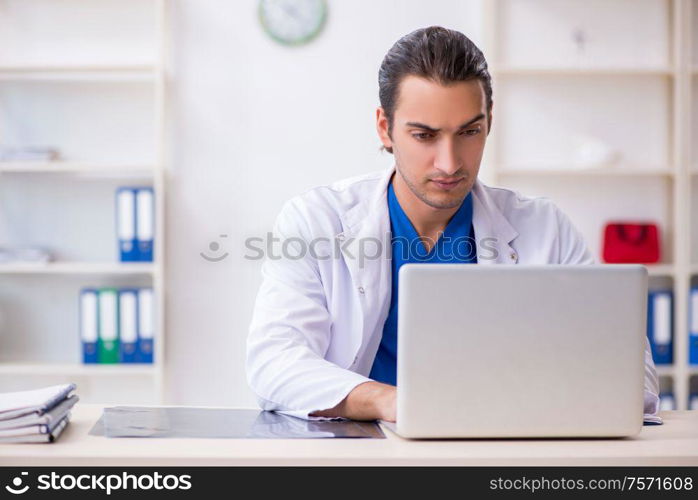 The young male doctor working in the clinic. Young male doctor working in the clinic