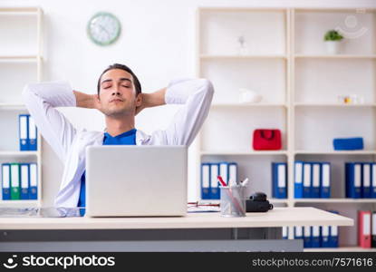 The young male doctor working in the clinic. Young male doctor working in the clinic