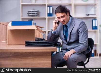 The young male employee being fired from his work . Young male employee being fired from his work