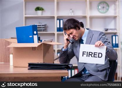 The young male employee being fired from his work. Young male employee being fired from his work