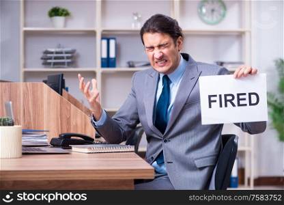 The young male employee being fired from his work. Young male employee being fired from his work