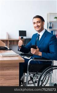 The young male employee in wheel-chair. Young male employee in wheel-chair