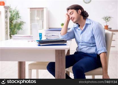 The young male employee working at home . Young male employee working at home 