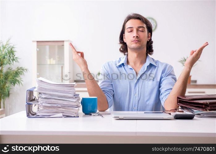 The young male employee working at home . Young male employee working at home 