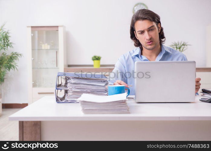 The young male employee working at home. Young male employee working at home