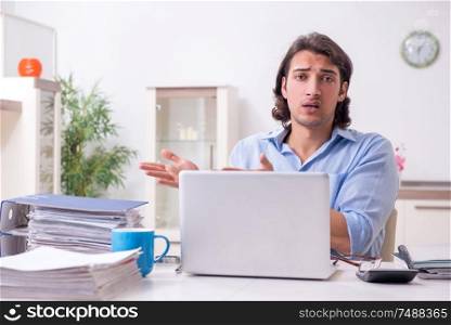 The young male employee working at home . Young male employee working at home