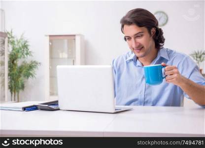 The young male employee working at home. Young male employee working at home