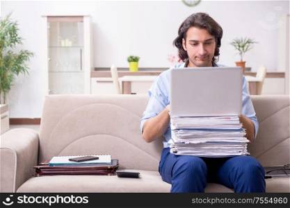 The young male employee working at home. Young male employee working at home