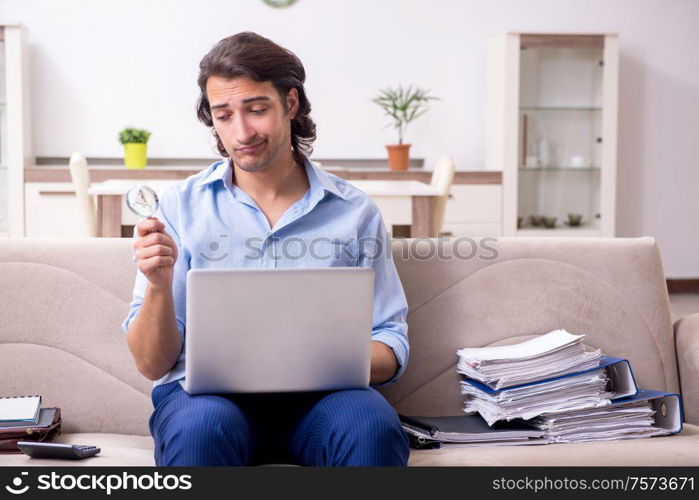 The young male employee working at home. Young male employee working at home