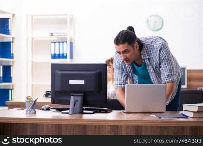 The young male it specialist in the office . Young male it specialist in the office 