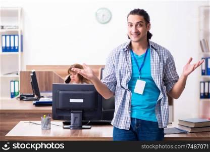 The young male it specialist in the office . Young male it specialist in the office