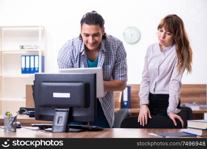 The young male it specialist in the office. Young male it specialist in the office