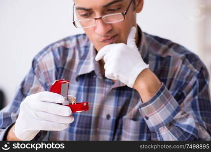 The young male jeweler at workshop. Young male jeweler at workshop