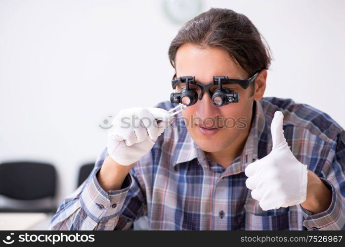 The young male jeweler at workshop. Young male jeweler at workshop