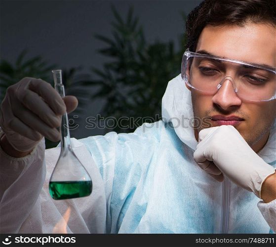 The young male lab chemist late at night in overtime time. Young male lab chemist late at night in overtime time