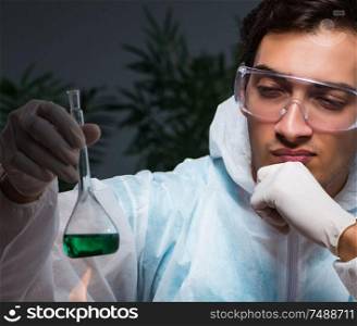 The young male lab chemist late at night in overtime time. Young male lab chemist late at night in overtime time