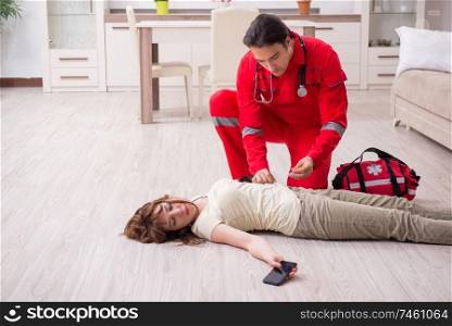 The young male paramedic visiting young woman  . Young male paramedic visiting young woman  