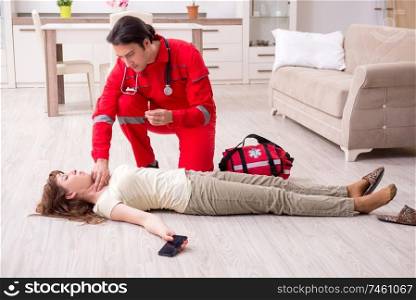 The young male paramedic visiting young woman  . Young male paramedic visiting young woman  