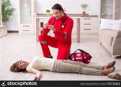 The young male paramedic visiting young woman. Young male paramedic visiting young woman