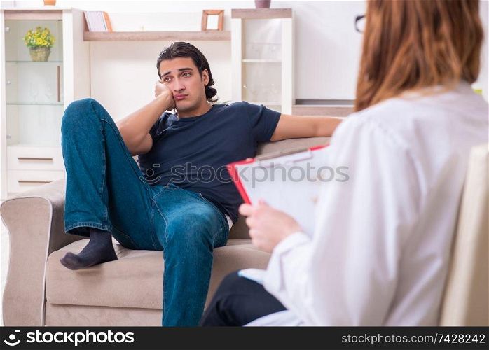 The young male patient discussing with female psychologist personal . Young male patient discussing with female psychologist personal 