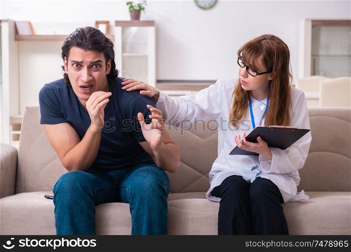 The young male patient discussing with female psychologist personal . Young male patient discussing with female psychologist personal