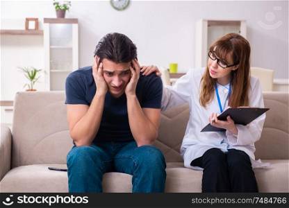 The young male patient discussing with female psychologist personal. Young male patient discussing with female psychologist personal