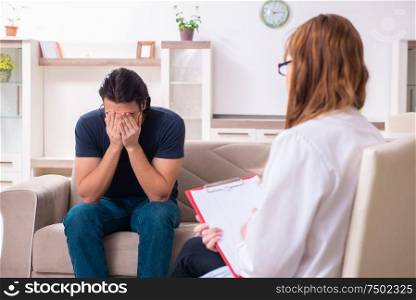 The young male patient discussing with female psychologist personal. Young male patient discussing with female psychologist personal
