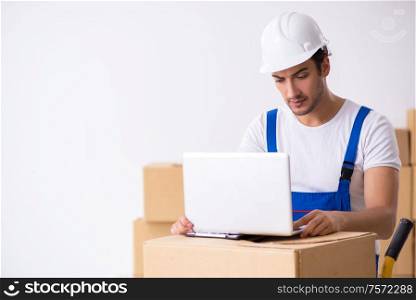 The young male professional mover doing home relocation. Young male professional mover doing home relocation
